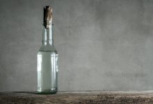 white vinegar bottle on wood table min e1644296843843