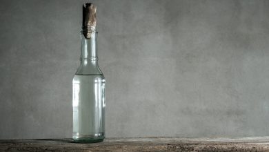 white vinegar bottle on wood table min e1644296843843