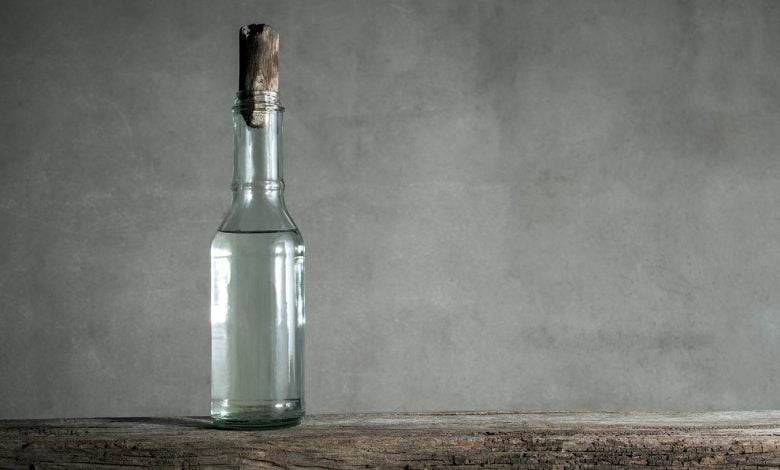 white vinegar bottle on wood table min e1644296843843