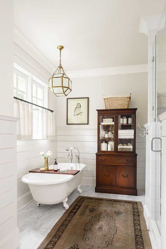 07 a chic faceted frosted glass chandelier over the tub is a beautiful and cool accent for a bathroom