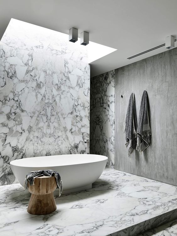 22 a skylight plus some additional lights on the ceiling make an accent on the tub and bring much light to it